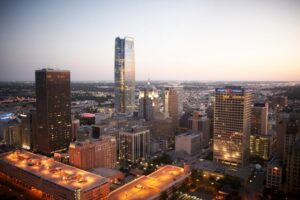 The setting sun is reflected off tall buildings in downtown Oklahoma City, OK