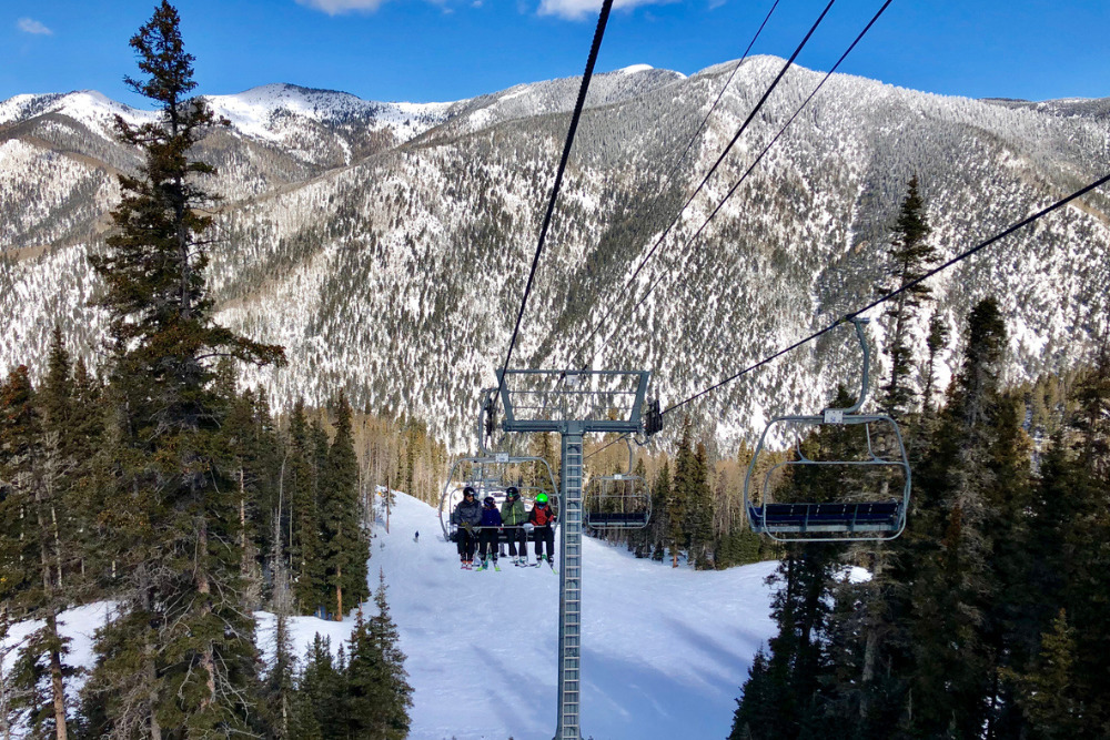 People enjoying skiing at Taos Ski Valley, New Mexico in the sunshine.