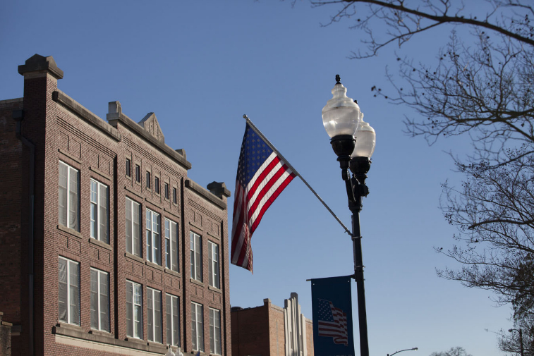 Picture of Downtown Smithfield, historic building with American Flag.