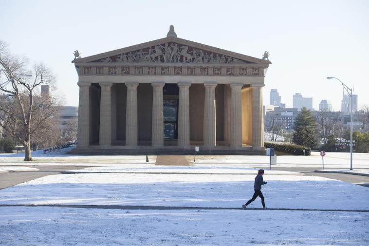 A jogger runs past the Parthenon in Nashville.
