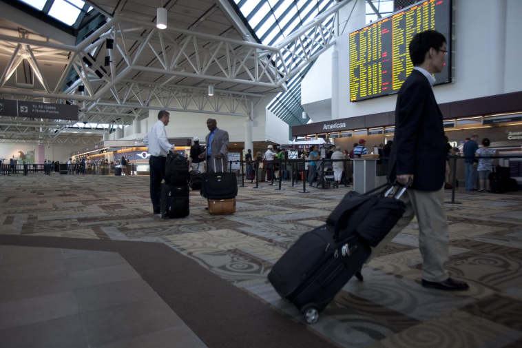 Travelers make their way through the Nashville international Airport or BNA.