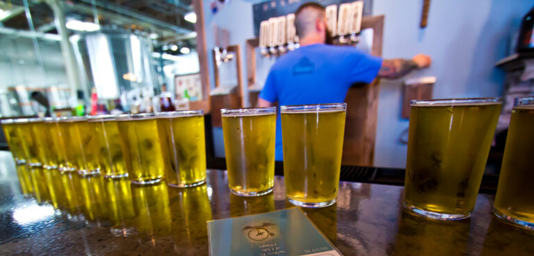 Beer glasses line the bar at 4 Hands Brewing Company in St. Louis