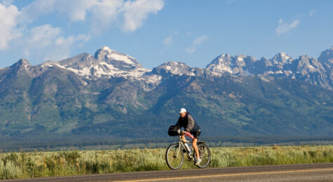 A cyclist rides through Grand Teton National park near Jackson, Wyoming