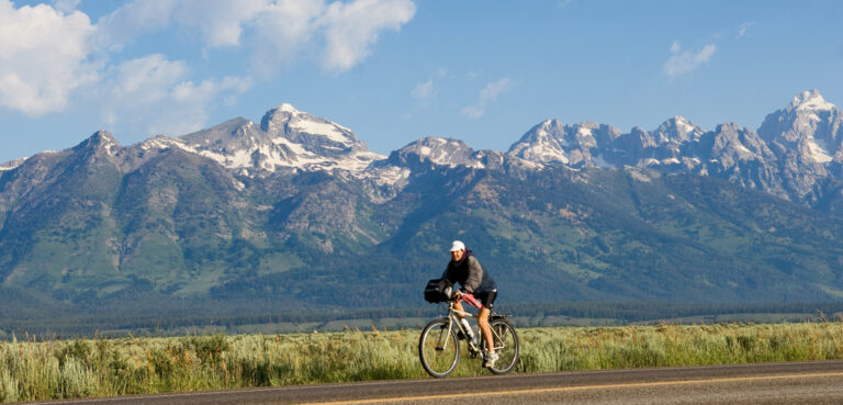 A cyclist rides through Grand Teton National park near Jackson, Wyoming