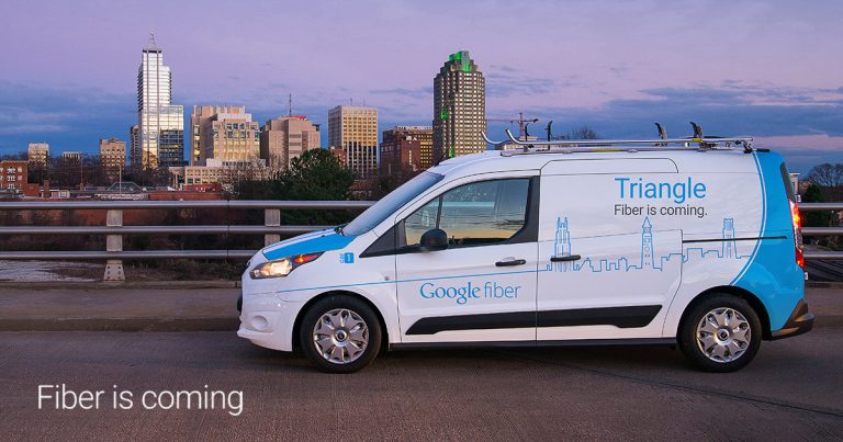 Google Fiber van on a bridge overlooking downtown Raleigh, NC