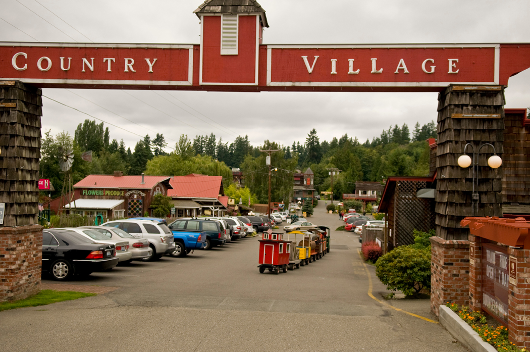 A children's train rolls down the street at Country Village in Bothell