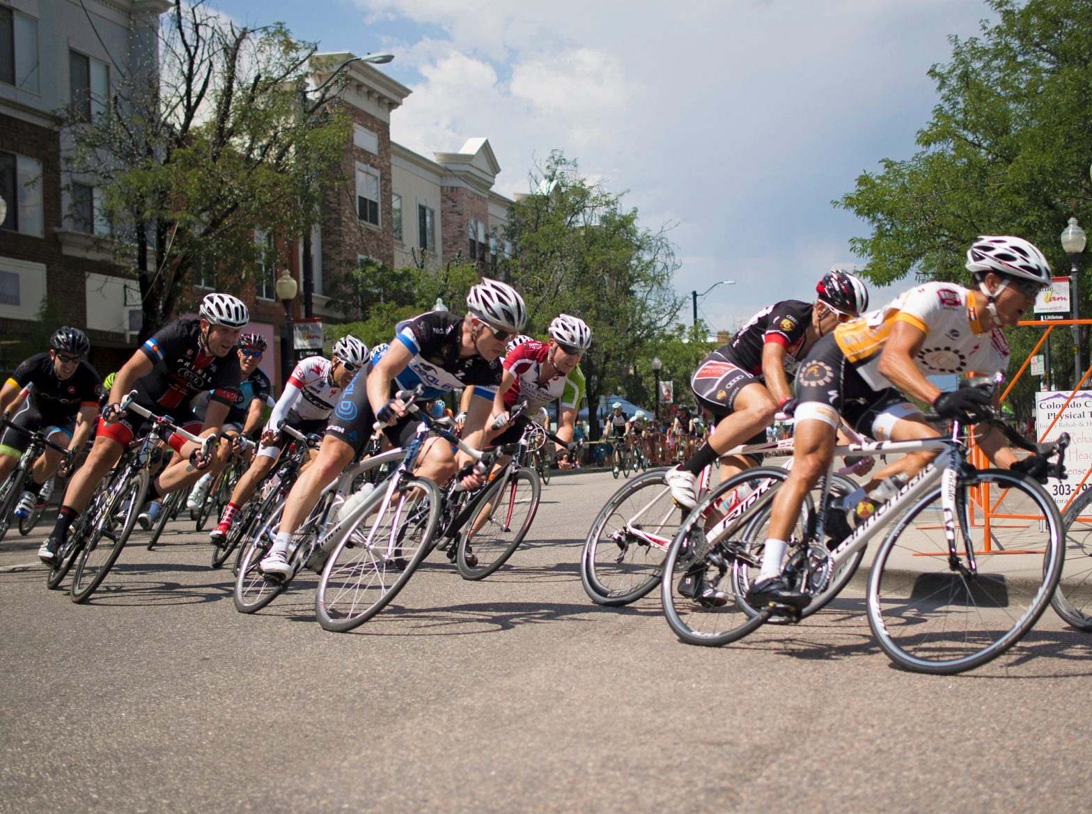 Cyclists race through the streets of downtown Littleton, CO