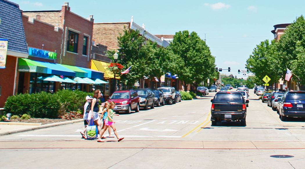 A mother and children walk across the main street in Downers Grove.