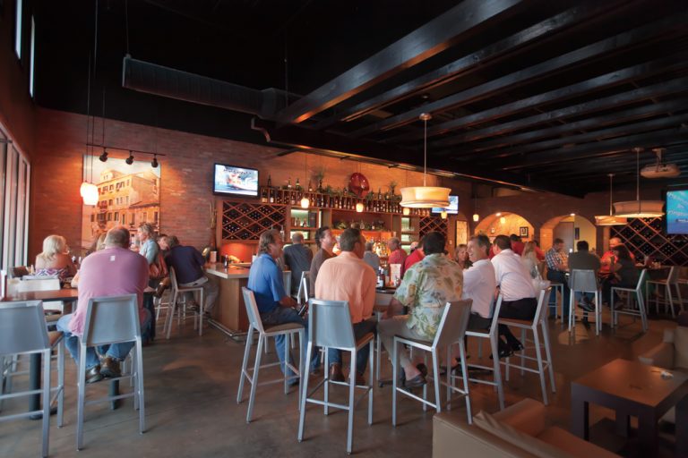 Patrons fill the bar area at Old Venice Pizza