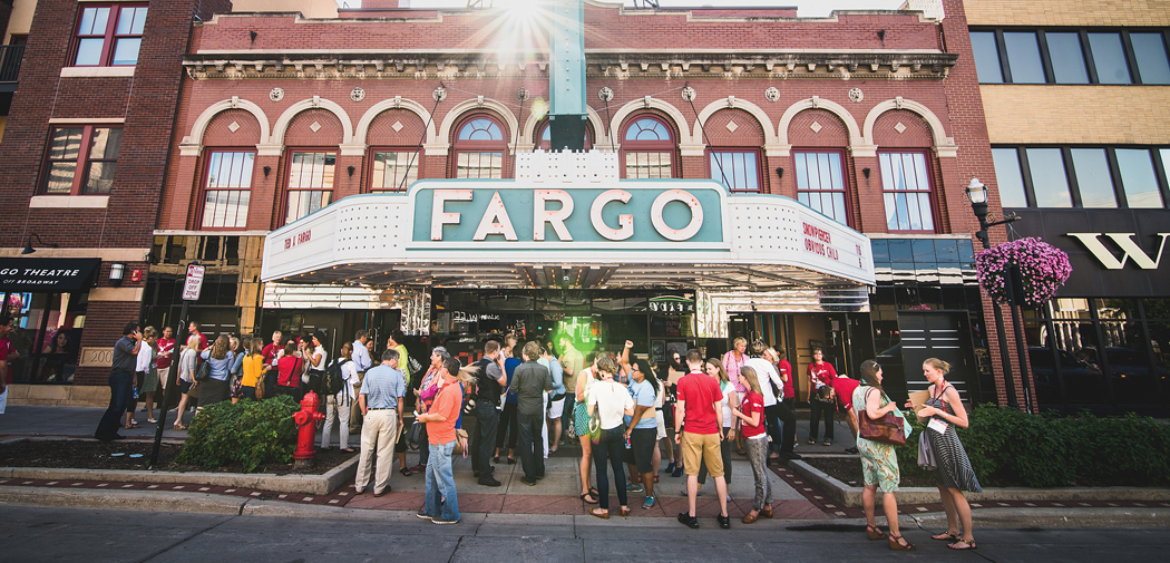 People gather under the marquee at the Fargo Theatre