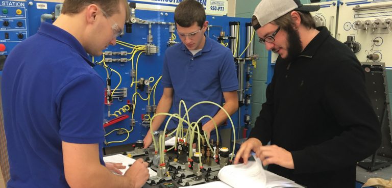 Students at Bluegrass and Technical college AMT Program work with electronic pieces and wires.
