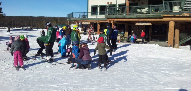 Children gather for a ski lesson at White Pines Ski Resort