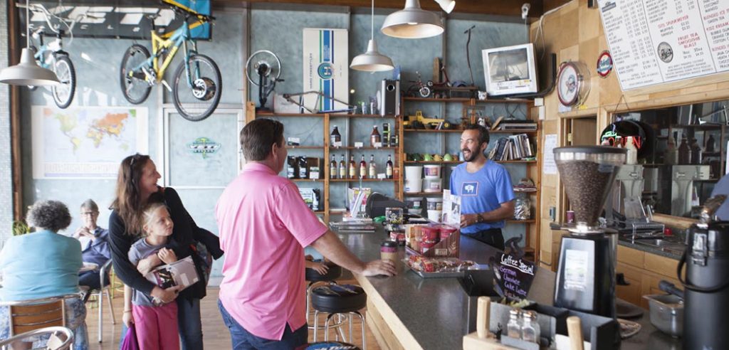 Jason Medler talks to customers at the Bike and Trike, which houses a coffee shop.