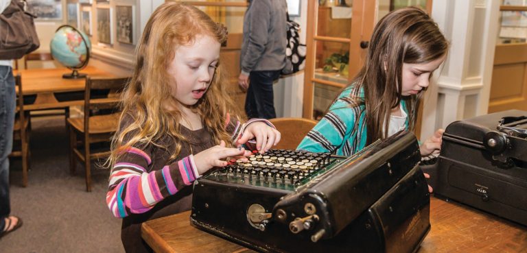 Girls play on a typewriter at the Oak Ridge Childrens Museum