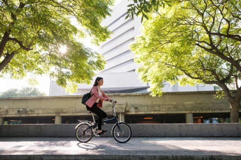 Woman biking to work stock