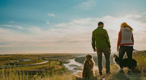 A couple who works remotely stands with their dog along the River’s Edge Trail in Great Falls, Montana.
