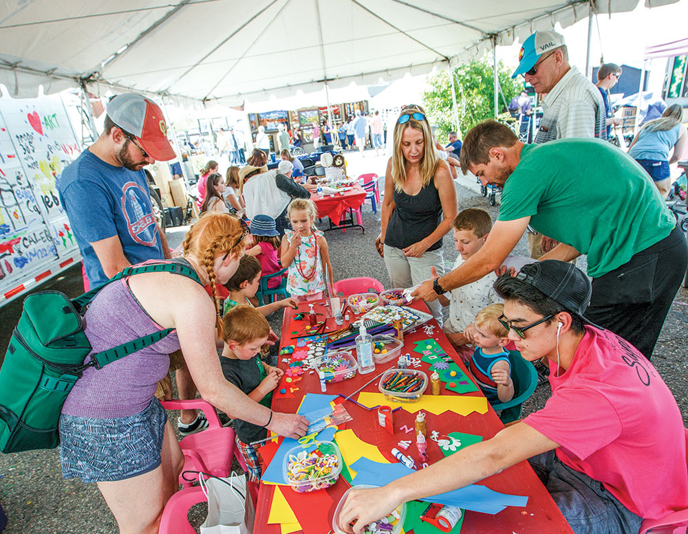 People surrounding a table at Artfest in Castle Rock, CO