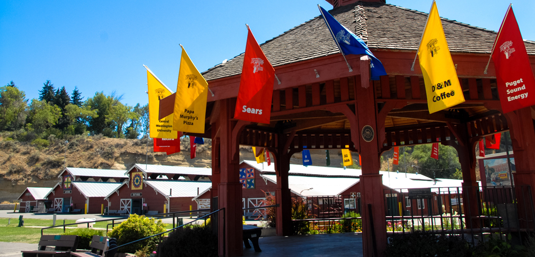 A pavilion in Ellensburg, WA with red and yellow flags.