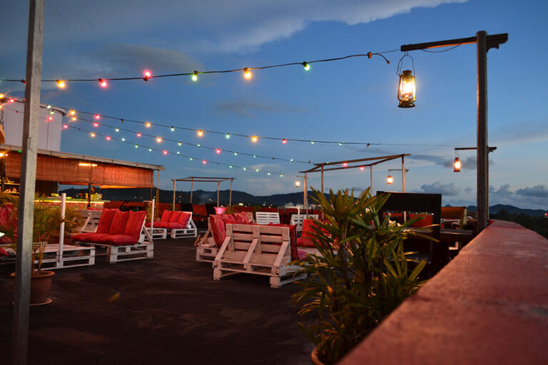 Rooftop bar with twinkle lights at dusk