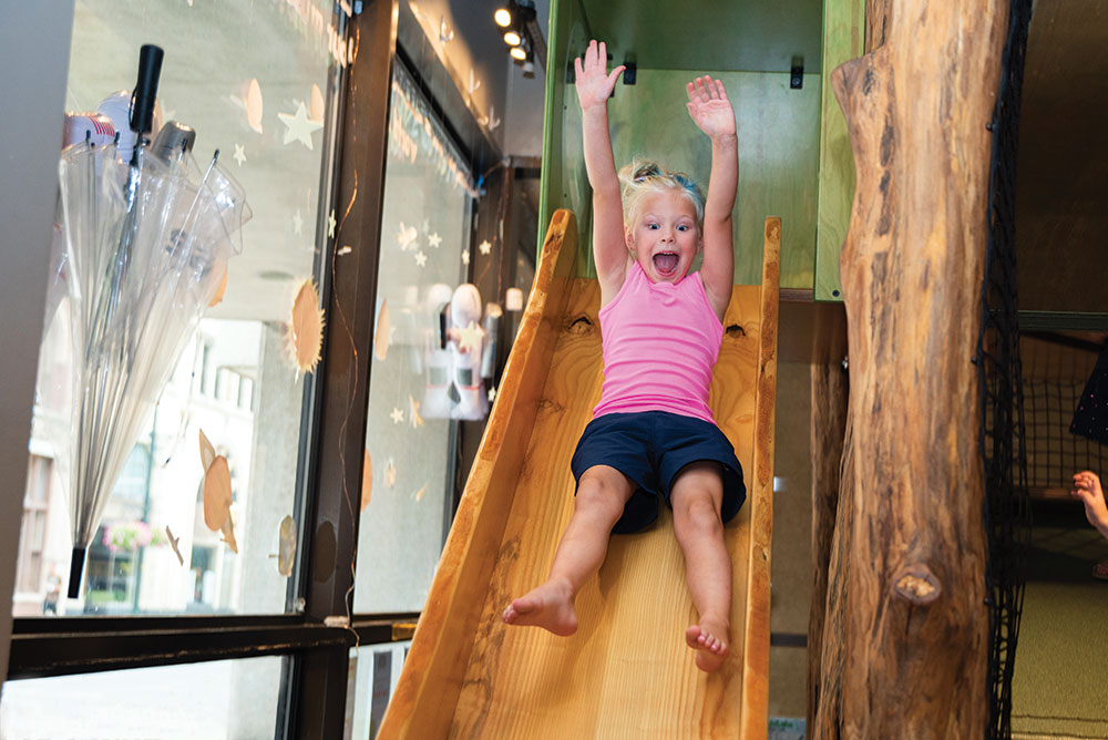 Little girl going down a slide