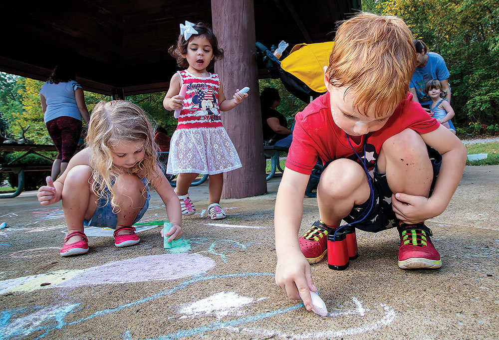 children drawing with chalk