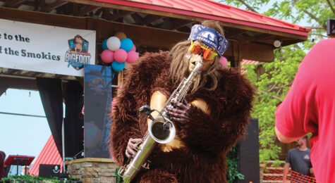 Bigfoot mascot playing saxophone