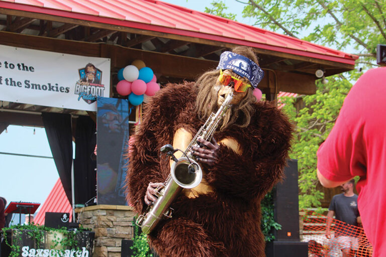 Bigfoot mascot playing saxophone