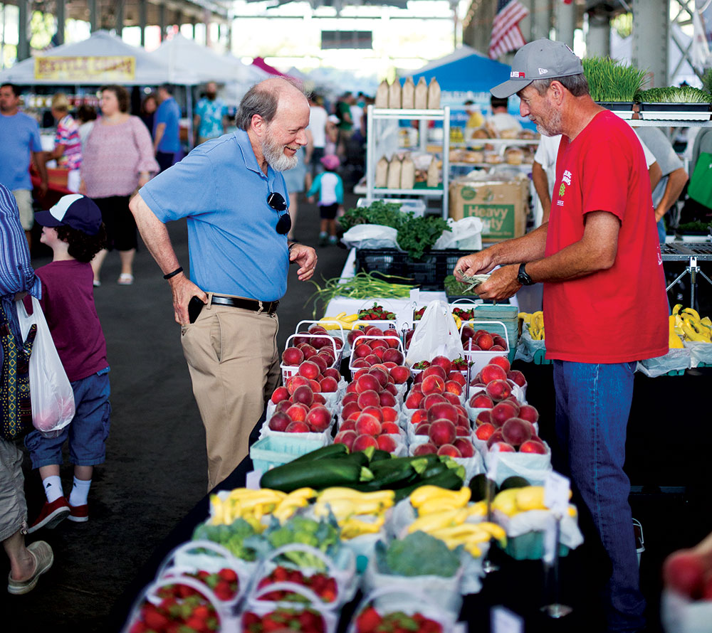 man buying fruit at market