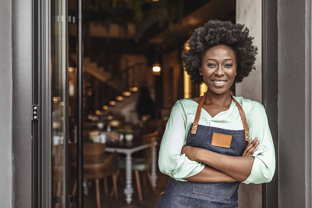 African woman in apron small business owner