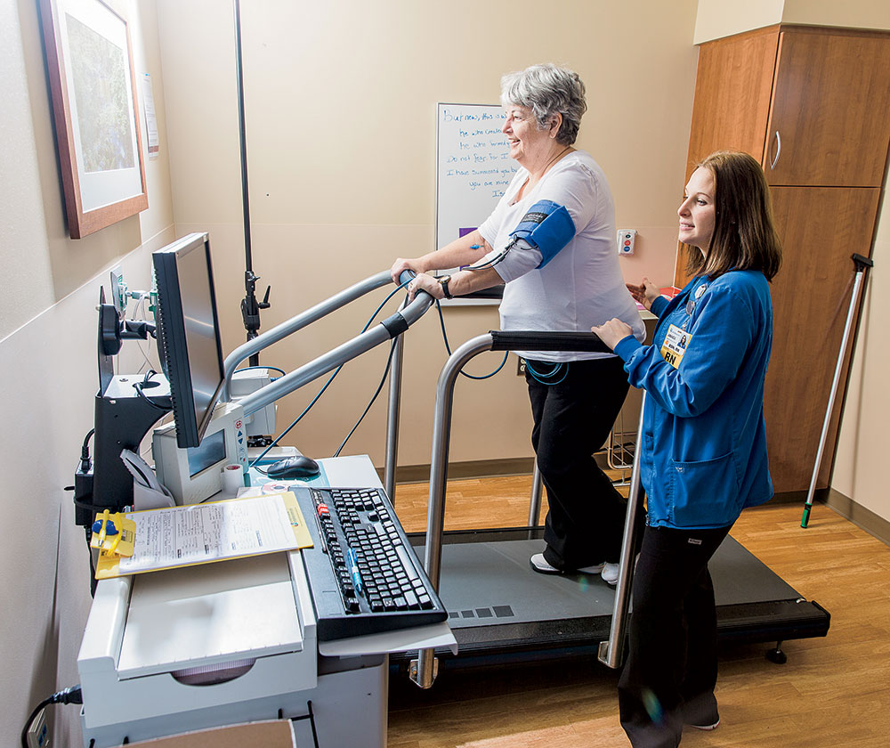 nurse works with patient on treadmill