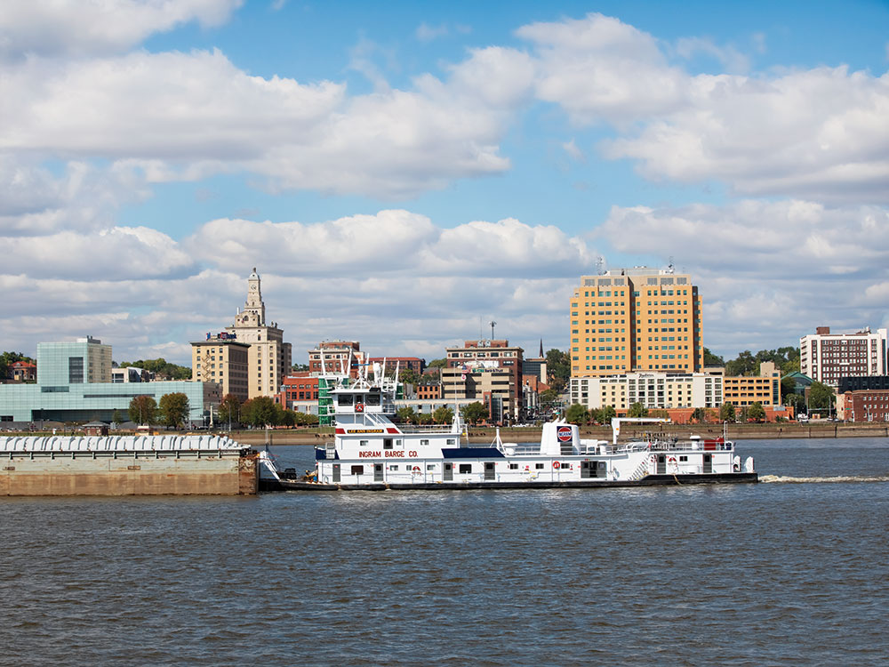 A river barge navigates the Mississippi in front of downtown Davenport, IA.