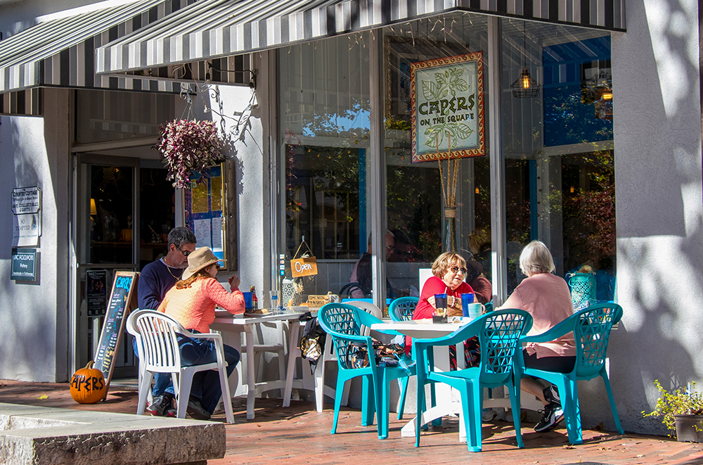 Dahlonega, GA - Dining alfresco on a warm autumn afternoon on the sidewalk in front of Capers, one of the several eateries on the historic public square.