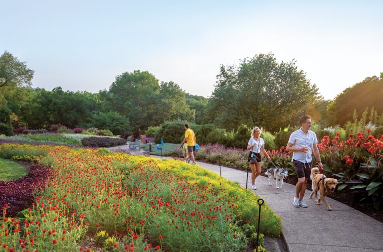 Visitors walk their dogs through the flower gardens during the Thursday Night out and Dog Nights of Summmer event at Cheekwood Estate and Gardens in Nasvhille, Tennessee. ©Journal Communications/Jeff Adkins
