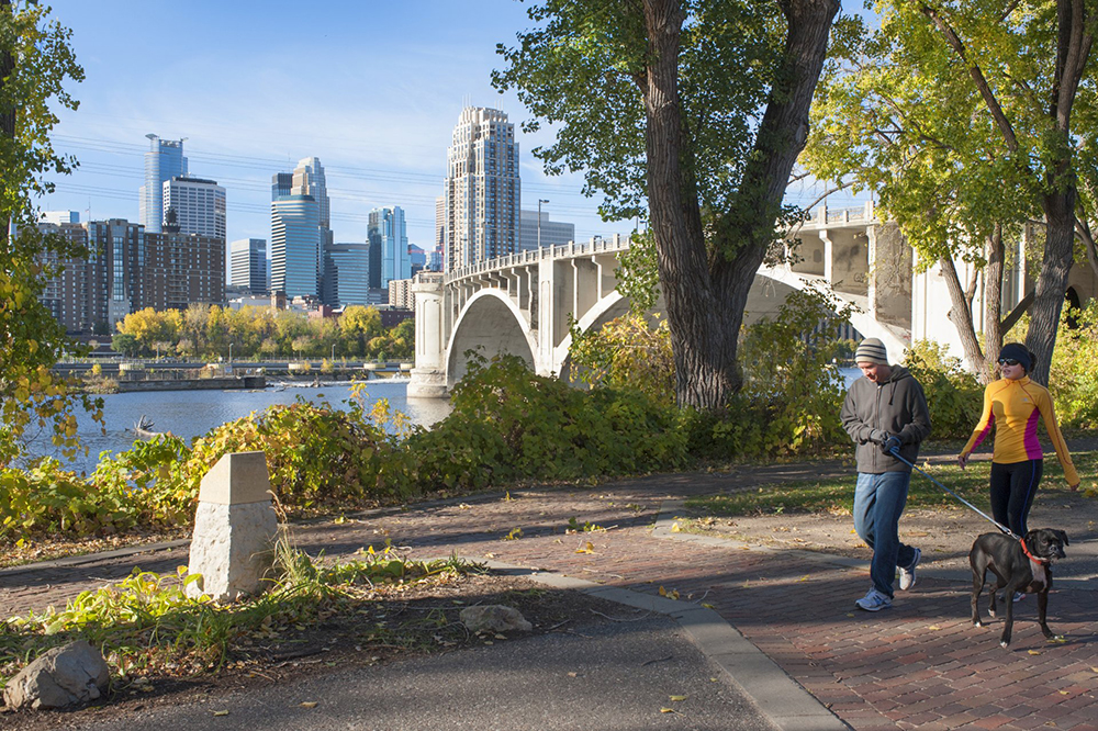 3rd Avenue Bridge and Minneapolis skyline along the Mississippi River in Fall.