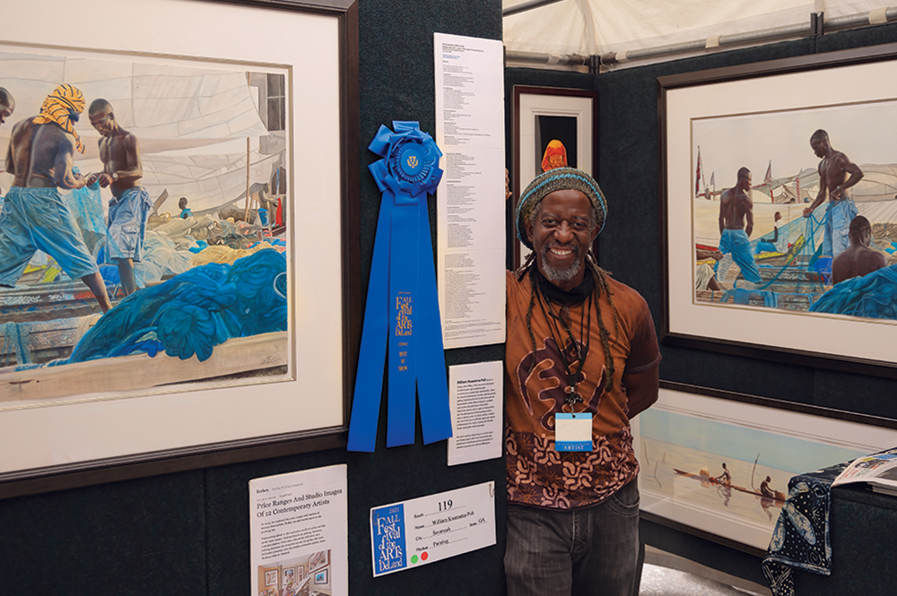 Man poses with art at the DeLand Festival, which is held in the Greater Daytona Region.