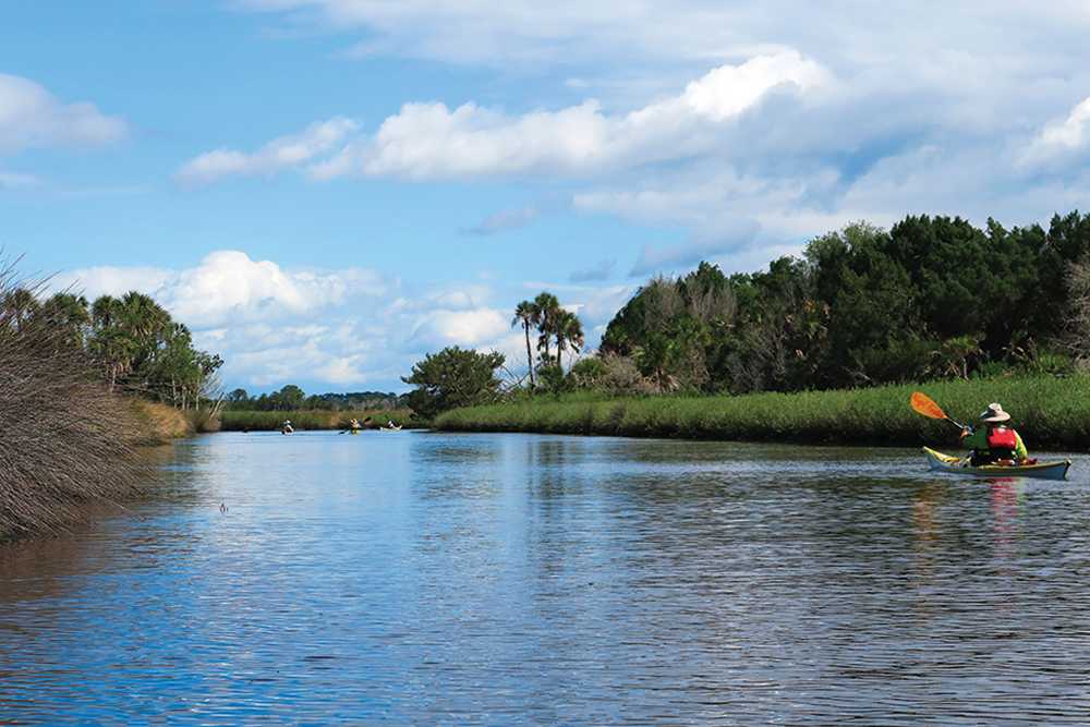 A person kayaking at Tomoka State Park, which is located in the Greater Daytona Region of Florida.