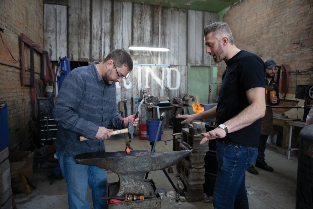 Jason Murphy, left, learns how to make a knife out of a railroad tie with help from Derik Lucas at the Redkey Blacksmith in Redkey. 