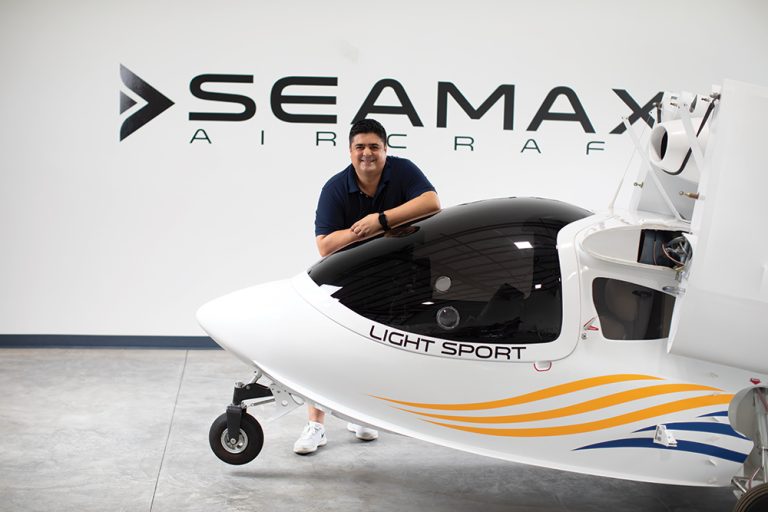 Shalom Confessor, is Executive Director of the SEAMAX, LLC USA Headquarters in Daytona Beach, Florida (part of the Greater Daytona Region). He is standing behind a SEAMAX Light Sport Aircraft. ©Journal Communications/Jeff Adkins