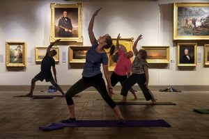 People participate in an evening yoga class inside the art gallery at the Museum of Arts and Sciences in Daytona (Greater Daytona Region). ©Journal Communications/Nathan Lambrecht