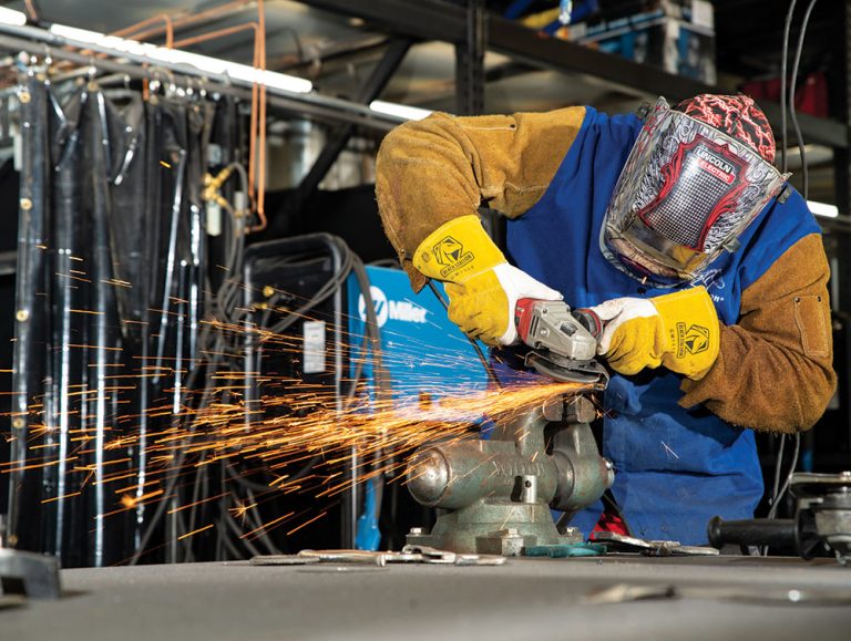 A student uses an angle grinder during a welding class at the FutureForward campus in Adams County, CO.