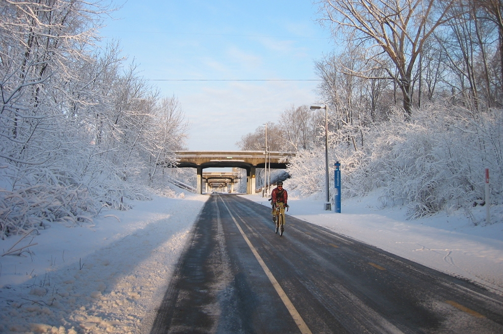 Man biking along the Midtown Greenway during the winter in Minneapolis, MN.