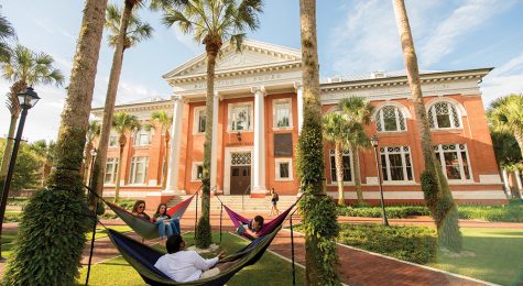 Students at Stetson University relax in hammocks outside. Stetson University is located in the Greater Daytona Region of Florida.