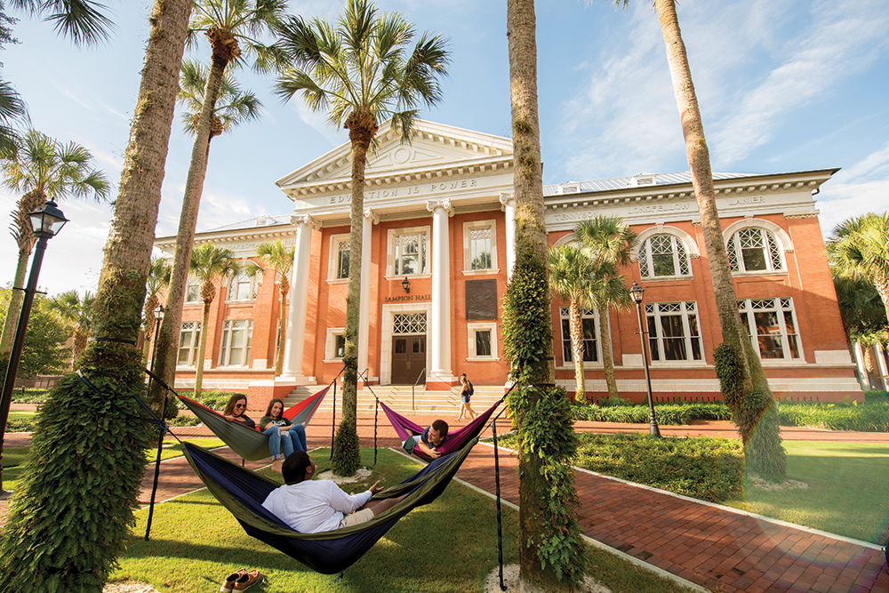 Students at Stetson University relax in hammocks outside. Stetson University is located in the Greater Daytona Region of Florida.