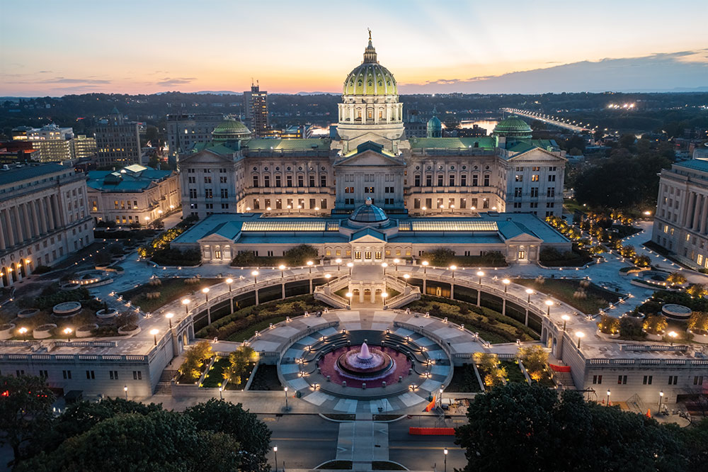 The Pennsylvania State Capitol lights up at dusk in downtown Harrisburg.