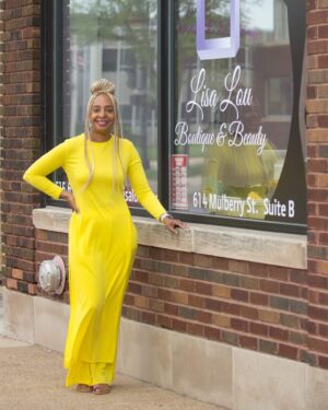 Lisa Bradford stands outside of her shop, Lisa Lou Boutique and Beauty, in Cedar Valley, IA.