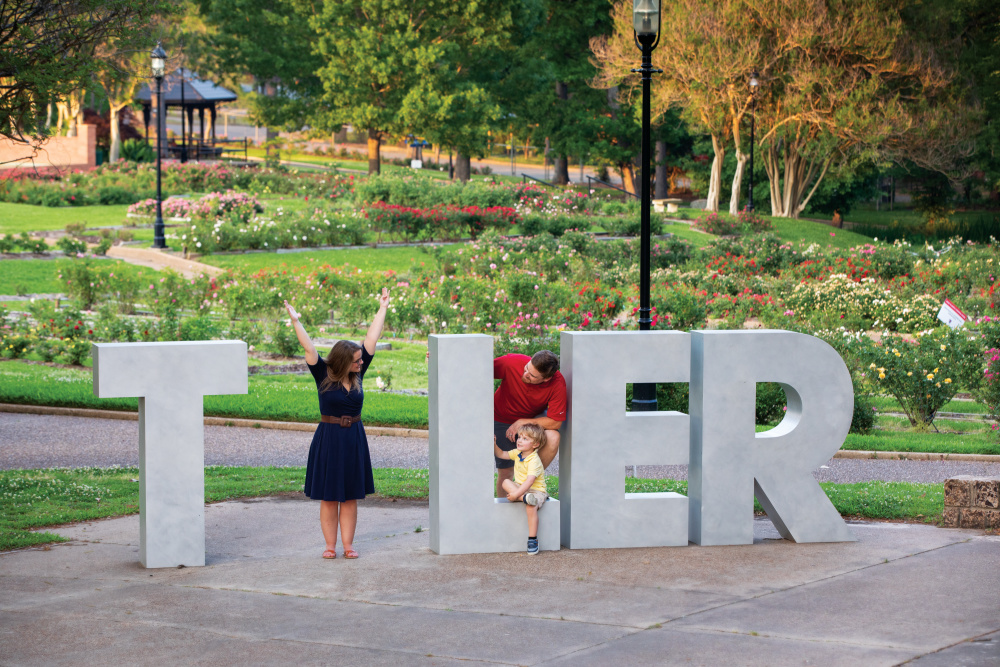 Cory and Holli Fourniquet make the “y” in Tyler with their son Tucker at the Tyler Rose Garden.