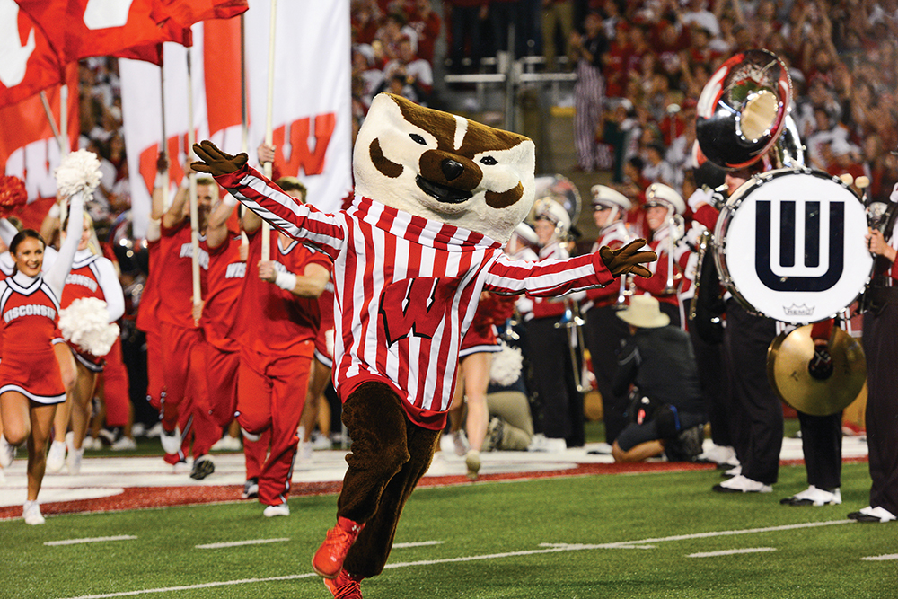 Mascot and cheer squad run on to the field at a University of Wisconsin-Madison football game.