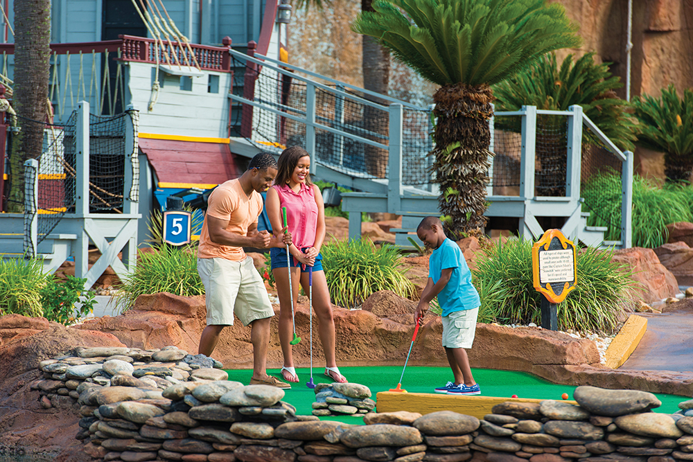 Family plays putt putt golf in Myrtle Beach, South Carolina.