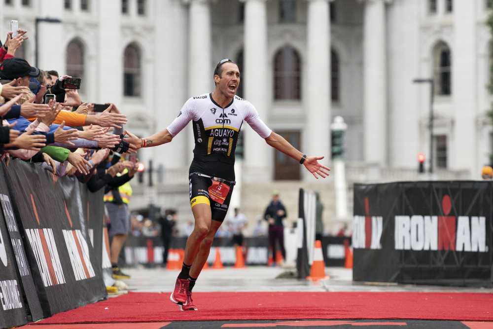 MADISON, WI - SEPTEMBER 08: Emilio Aguayo Munoz of Spain celebrates as he approaches the finish line to win the IRONMAN Wisconsin on September 8, 2019 in Madison, Wisconsin. The IRONMAN Wisconsin triathlon returns to the university town of Madison where participants from around the world converge for the mid-western race through southern Wisconsin. (Photo by Patrick McDermott/Getty Images for IRONMAN)