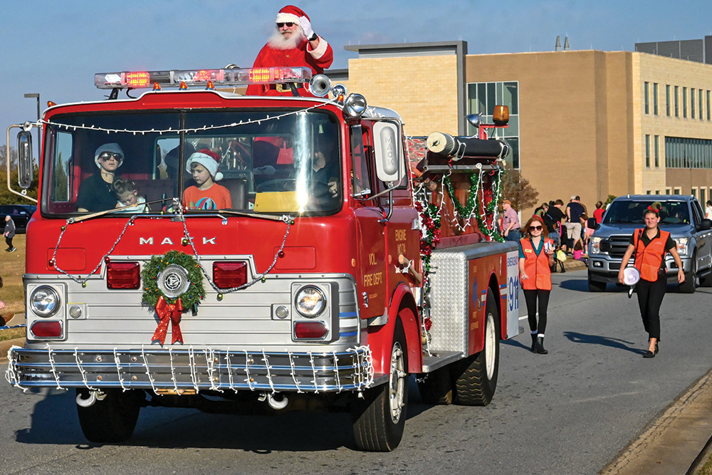 A firetruck and people walk down the street at the Warner Robins Christmas Parade in the Robins Region area of Georgia.